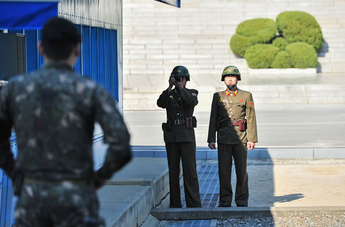 Soldados norcoreanos (de frente) y surcoreanos (de espaldas) en la línea de frontera entre las dos Coreas.